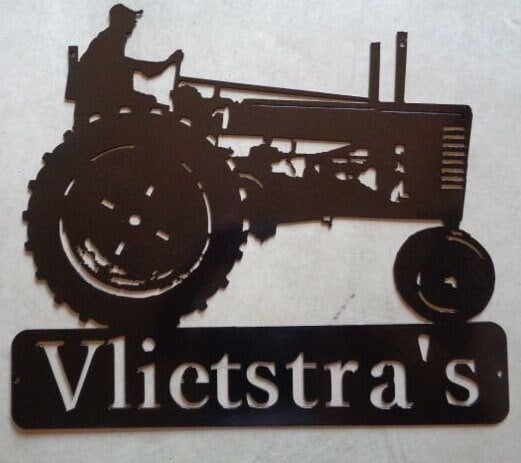 metal tractor sign with farmer on antique tractor