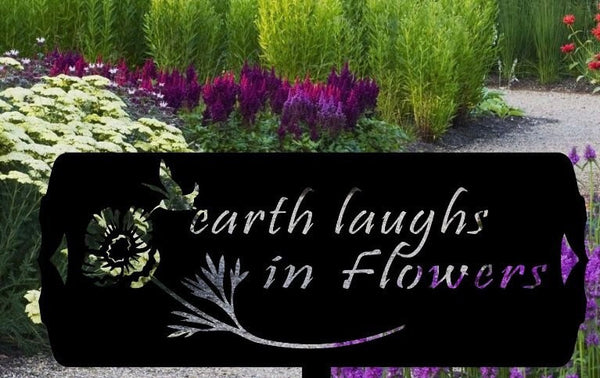 Metal garden sign, earth laughs in flowers